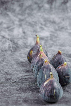 Purple ripe figs on a marble backgroundの写真素材