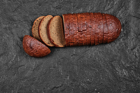Sliced black bread on dark backgroundの写真素材