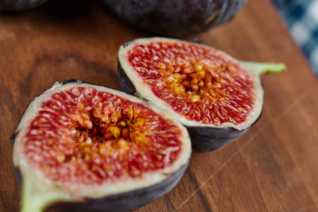 Half slices of ripe fig on a wooden board
