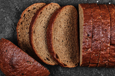 Sliced black bread on dark backgroundの写真素材