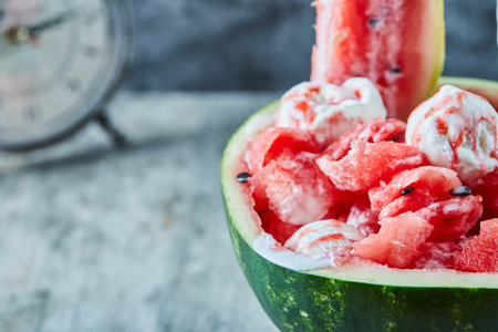 Ice-cream inside of juicy watermelon and clockの写真素材