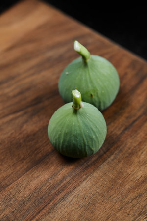 Ripe green figs on a wooden tableの写真素材