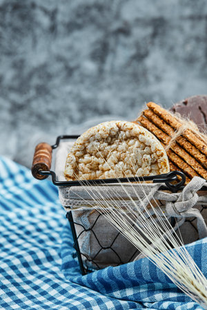 Basket of biscuits with a tablecloth on a marble backgroundの写真素材