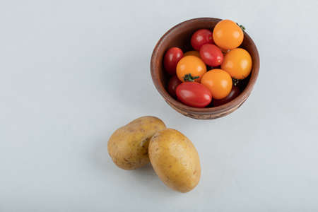 Fresh vegetables. Red cherry tomatoes and potatoesの写真素材