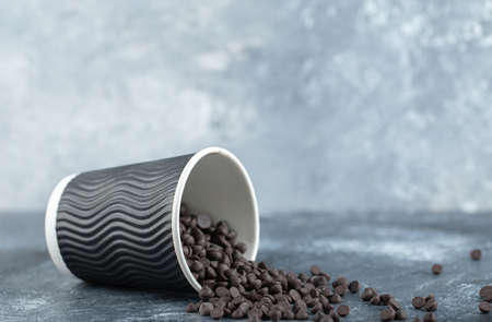 Close up photo pile of small chocolate on grey backgroundの写真素材