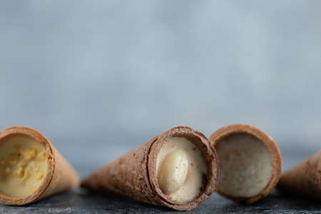 Tifferent kinds Sweet conus candies on grey background. Close up photo