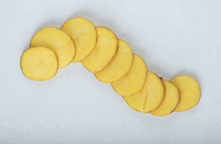 Stack of sliced potato on white baclgroundの写真素材