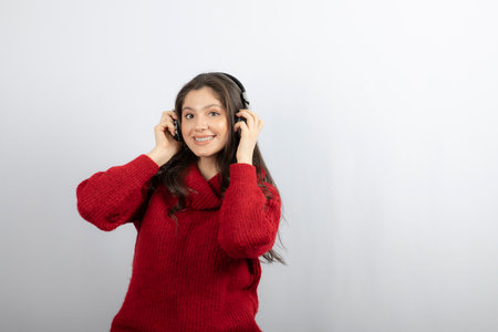 Positive teenager listens music in stereo headphonesの写真素材