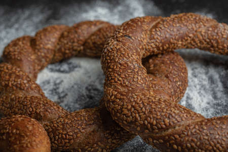 Freshly baked Turkish simit on flour . close up photo