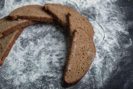 Stack of sliced breads on flour background