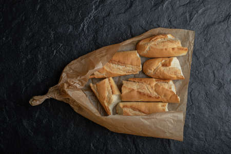 Freshly baked bread slices, on food paper