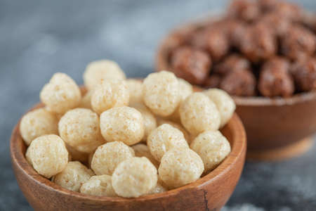 Wooden bowls with sweet corn balls on a gray backgroundの写真素材