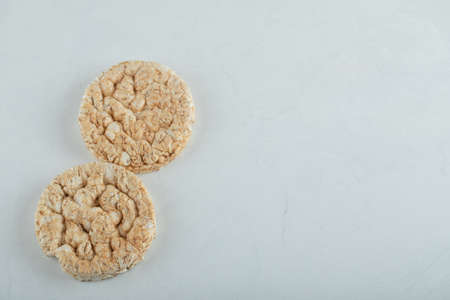 Delicious round crispbread on light gray backgroundの写真素材