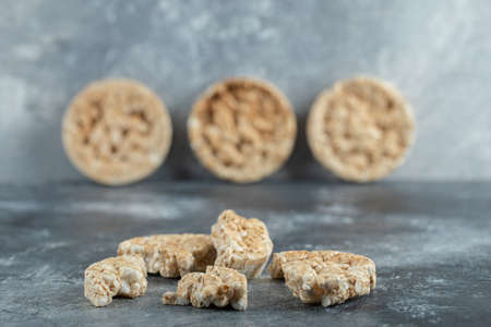 Broken crispbread slices on big marble background