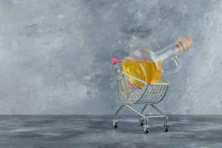 Bottle of olive oil in metal trolleyの写真素材