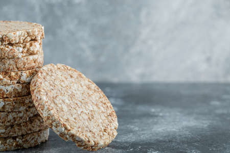 Stack of tasty crispbread on marble backgroundの写真素材