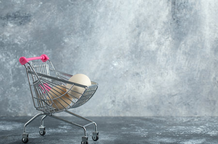 Uncooked organic eggs in metal trolley cartの写真素材