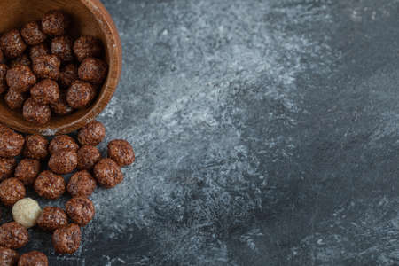 A wooden bowl with sweet corn balls on a gray backgroundの写真素材