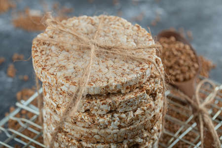 Stack of rice cakes and scattered buckwheat on marble surfaceの写真素材