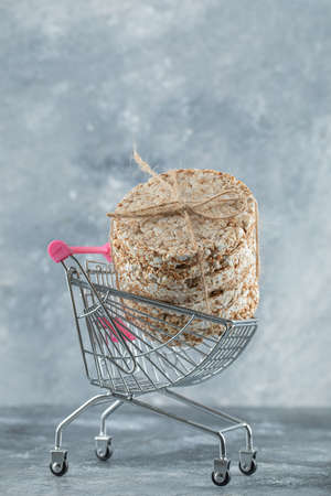 Stack of delicious crispbread in small shopping cart