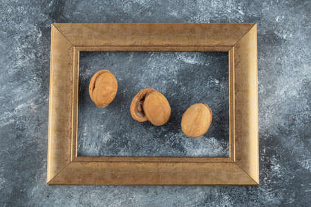 Sweet walnut cookies on a golden frameの写真素材