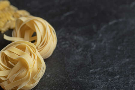 Uncooked nest noodles on a dark backgroundの写真素材