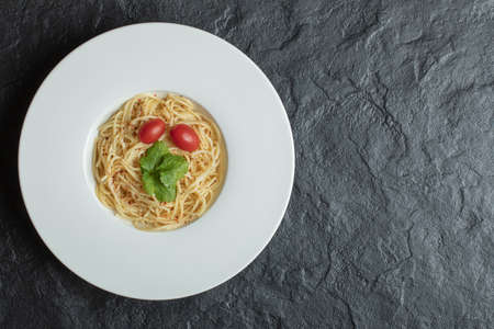 Delicious spaghetti with greens and cherry tomatoの写真素材