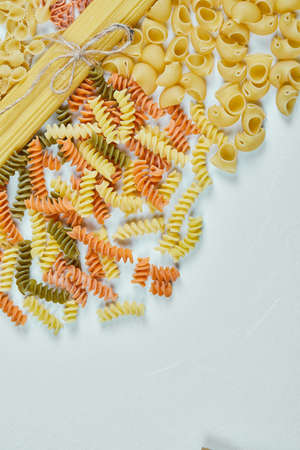 Assorted types of pasta on blue background