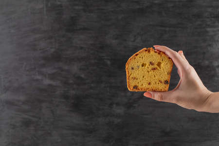 Holding a slice of pie with black sultana in itの写真素材