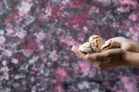 Holding crispy butter cookies in the hand
