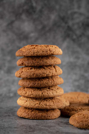 A stock of oatmeal cookies on grey concrete background
