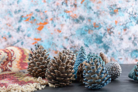 Colorful oak tree cones on a piece of red pattern ethnic rugの写真素材