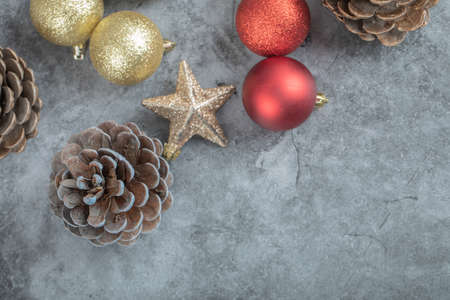 Christmas tree cones, balls and stars isolated on grey marble backgroundの写真素材