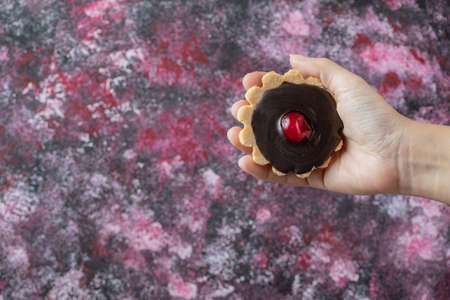Tartalettes with chocolate ganache and red cherry