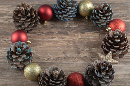 Natural oak tree cones on a wooden deck with glittering ornaments aroundの写真素材