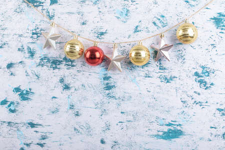 Colorful ornaments hanged from the rustic thread on blue white pattern