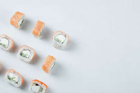 Salmon rolls with cream cheese isolated on white backgroundの写真素材