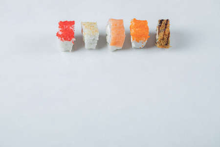 Sushi rolls with red caviar and salmon isolated on white backgroundの写真素材