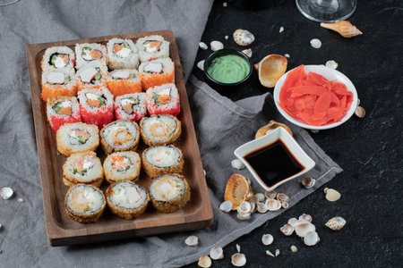 Sushi set on a wooden platter with soy sauce, ginger and wasabiの写真素材