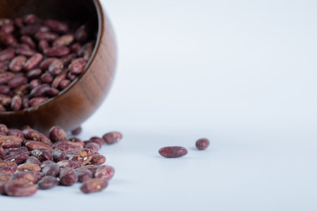 A small wooden bowl full of kidney beansの写真素材
