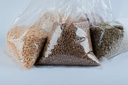 Various raw beans and corns inside plastic pocketsの写真素材