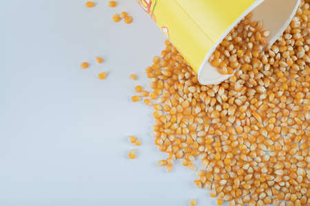 A bucket with raw popcorn on a dark backgroundの写真素材