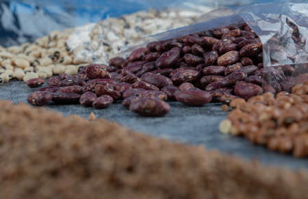 Different kinds of beans packed on a gray backgroundの写真素材