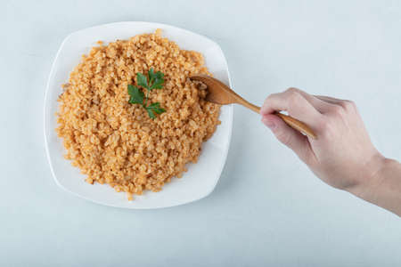 Delicious bulgur pilaf on a white plateの写真素材
