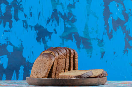 A wooden cutting board with slices of bread