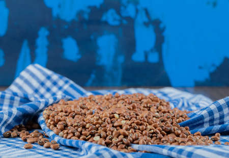 Pile of red beans on striped tableclothの写真素材