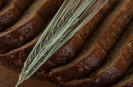 Close up view of black bread slices with wheatの写真素材