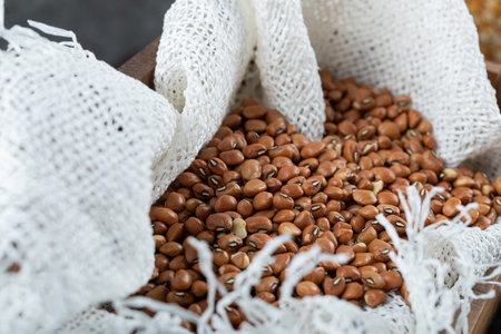 Brown unprepared kidney beans on a wooden basketの写真素材