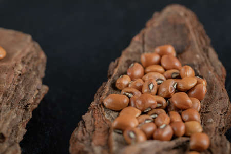 Pile of red beans on wooden piecesの写真素材