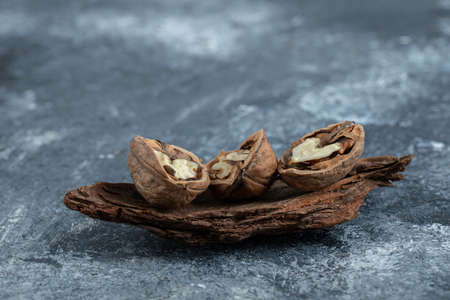 Some of openesd healthy walnuts on a gray background